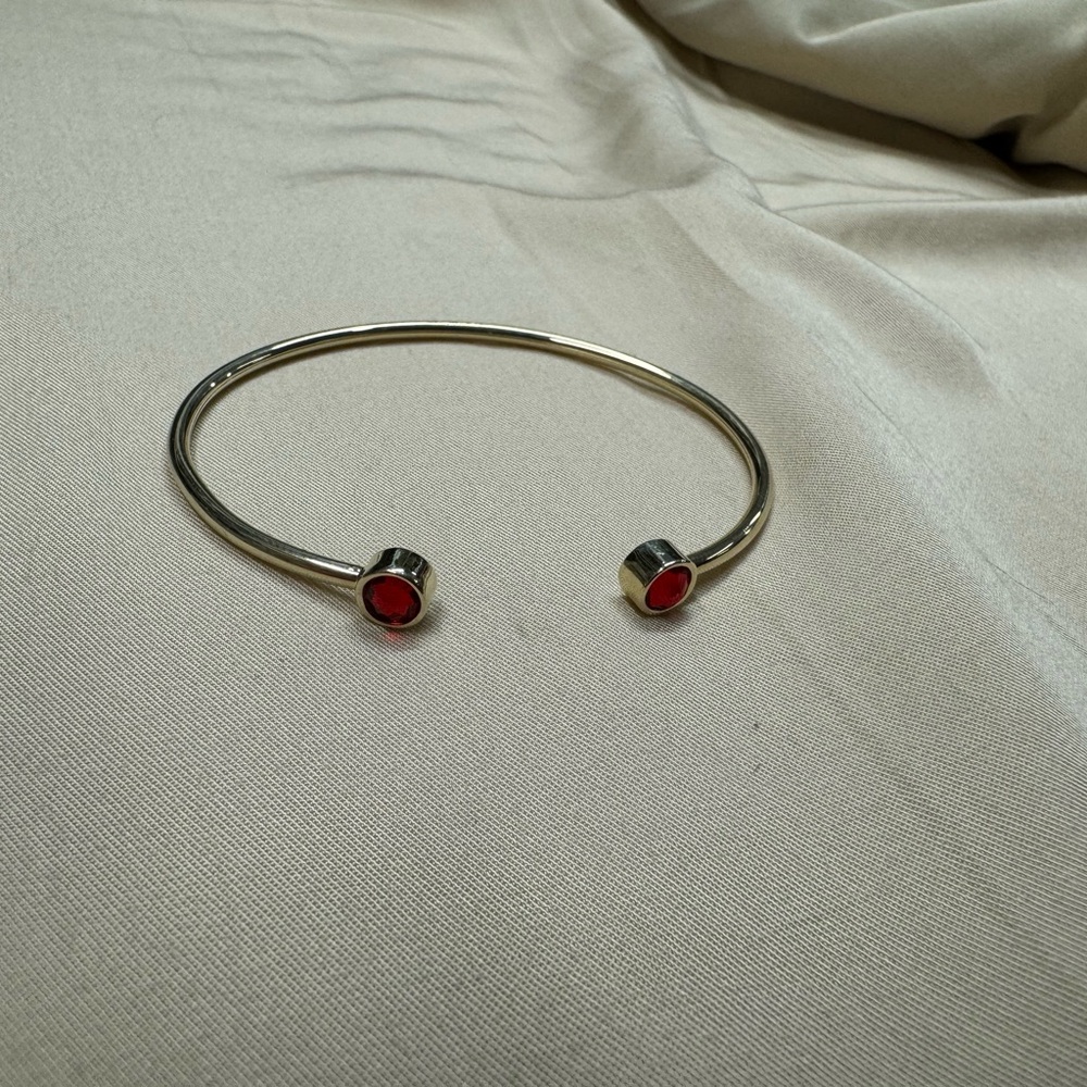 Alex + Ani brass gold cuff with ruby red crystal accent gem. Nickel free. Flex